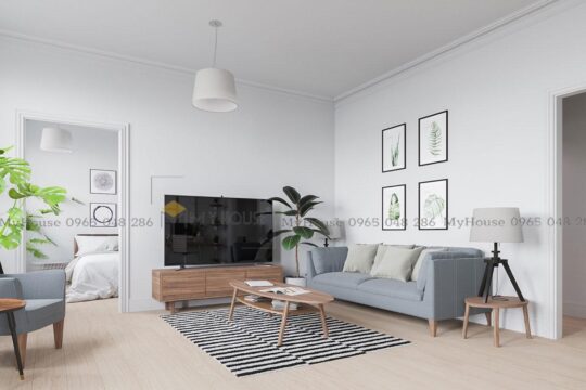 Phòng khách được bố trí đơn giản cùng với bộ sofa văng tông màu nhã nhặn
